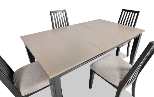 Blake 5 Piece Graphite & Gray Upholstered Dining Set with four gray fabric polyester cushioned chairs and extendable graphite-finished MDF and hardwood table.