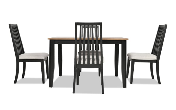 Blake 5 Piece Black & Natural Upholstered Dining Set with four gray polyester fabric cushioned slat-back chairs and an extendable black and natural wood farmhouse-style table.