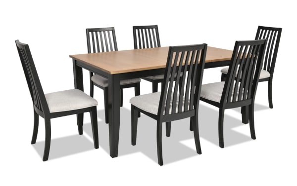 Blake 7 Piece Black & Natural Upholstered Dining Set with six gray fabric polyester cushioned slat-back chairs and extendable MDF, hardwood, rubberwood, birch veneer farmhouse-style table.