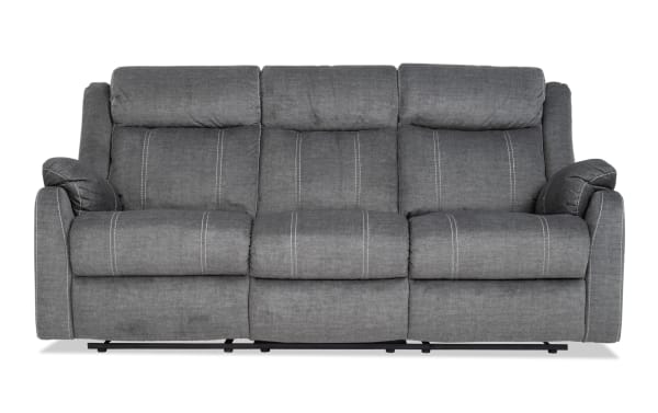 Lagoon Gray 81'' manual reclining sofa in transitional style with soft polyester fabric upholstery, featuring plush cushions and adjustable recline.