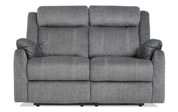 Lagoon Gray 57'' Manual Reclining Loveseat in gray polyester fabric with transitional style, featuring plush cushions and manual recline for adjustable comfort.