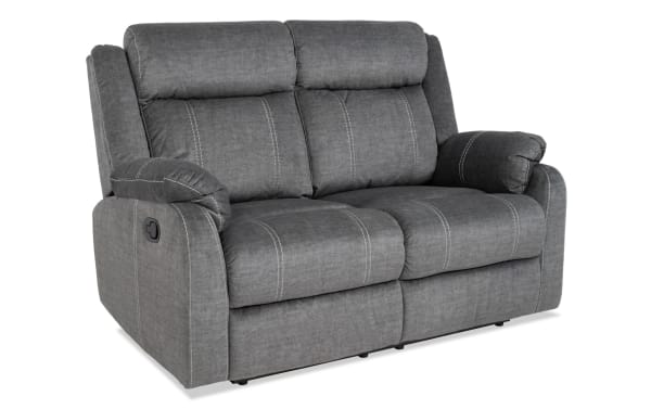 Lagoon Gray 57'' manual reclining loveseat in gray polyester fabric with transitional style, featuring padded armrests and stitched cushions for adjustable comfort.
