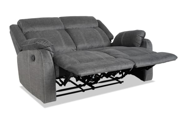 Lagoon Gray 57'' manual reclining loveseat in gray polyester fabric with transitional style, featuring plush cushions and adjustable footrests.