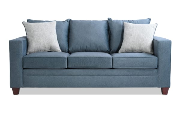 Tracy Teal 82'' transitional sofa with blue polyester fabric upholstery, three seat cushions, two light gray accent pillows, and wooden legs.