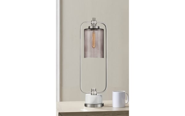 Liam transitional table lamp with brushed nickel metal frame, white marble base, and smoked glass shade, featuring an exposed filament bulb and easy on/off switch.