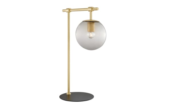 Ezra Gold Table Lamp with transitional style, nickel frame, black base, and clear glass globe shade showcasing exposed bulb for warm ambient lighting.