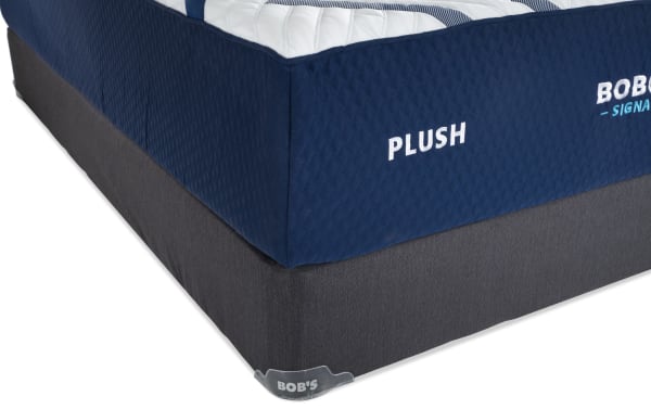 Corner view of Bob-O-Pedic Signature Gel 13.5'' Queen Dual Standard Mattress Set in plush style, featuring navy blue quilted fabric and dark gray foundation.