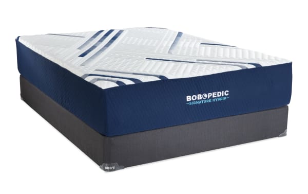 Signature Hybrid 13.5'' Full Plush Standard Mattress Set by Bob-O-Pedic, featuring a white quilted top with blue accents and a navy blue side panel on a gray foundation base.