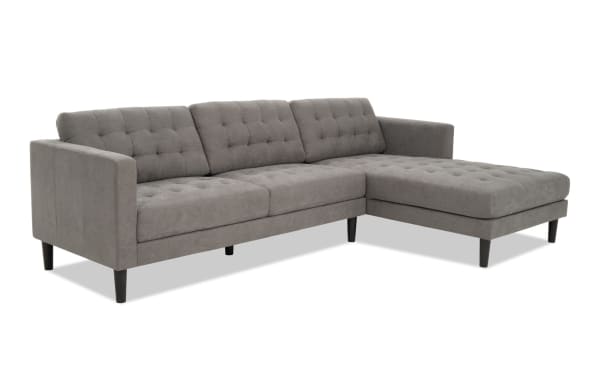Metro Charcoal 112'' 2 Piece Right Arm Facing Chaise Sectional in gray polyester fabric with tufted cushions, track arms, and tapered black legs, transitional style.