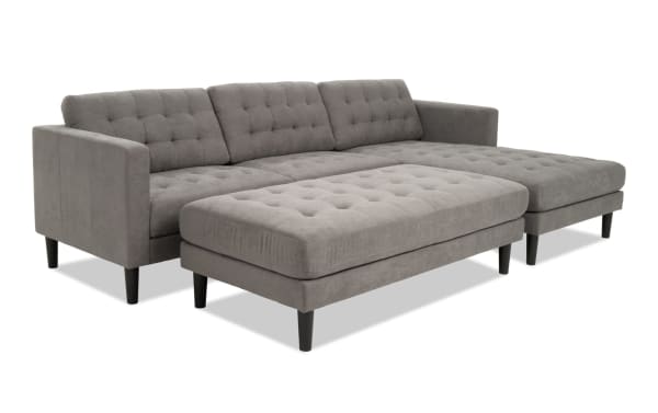 Metro Charcoal 112'' 2-piece right arm facing chaise sectional with ottoman in gray polyester fabric, tufted cushions, track arms, and transitional style.