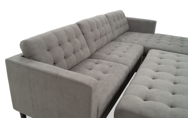 Metro Charcoal 112'' 2-piece right arm facing chaise sectional with ottoman, featuring tufted charcoal gray polyester fabric, track arms, and transitional style.