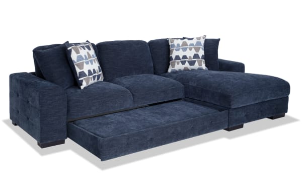 Playground Navy 116'' 2 Piece Right Arm Facing Pop-Up Sleeper Chaise Sectional in navy polyester fabric. Contemporary style with hand-tufted detailing, deep memory foam cushions, oversized accent pillows, and hidden chaise storage. Versatile fabric sectional with sleeper pop-up loveseat for extra convenience.