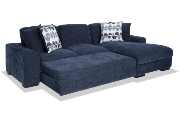 Contemporary Playground Navy 116" 2-piece right arm facing pop-up sleeper chaise sectional with navy polyester fabric, memory foam cushions, tufted details, oversized accent pillows, and hidden chaise storage.