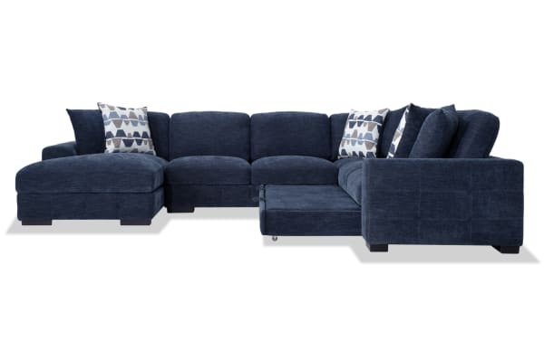 Contemporary Playground Navy 4-piece left arm facing sectional with pop-up sleeper chaise, navy polyester fabric, memory foam cushions, and oversized accent pillows.