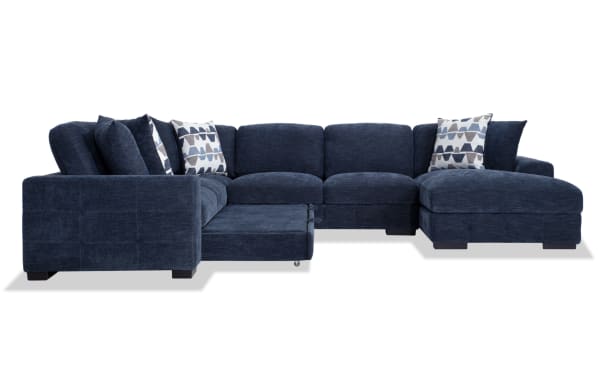 Playground Navy 145" 4-piece right arm facing sectional with pop-up sleeper chaise, navy polyester fabric, memory foam cushions, tufted texture, and oversized accent pillows.
