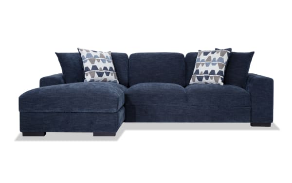 Playground Navy 116'' 2 Piece Left Arm Facing Pop-Up Sleeper Chaise Sectional in navy polyester fabric with memory foam cushions, tufted texture, and oversized accent pillows.