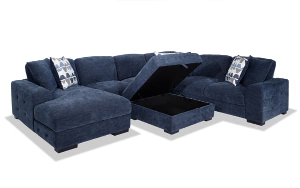 Playground Navy 145'' 4-piece left arm facing pop-up sleeper chaise sectional with storage ottoman, navy polyester fabric, contemporary style, deep cushions with memory foam, hand-tufted detailing, and oversized accent pillows.