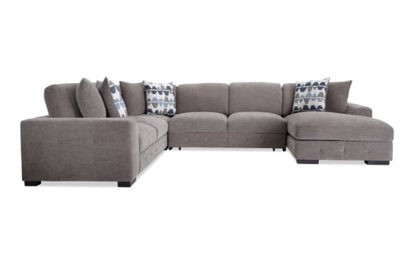 Playground Gray 145'' 4-piece right arm facing sectional with pop-up sleeper chaise, gray polyester fabric, memory foam cushions, tufted detailing, and storage ottoman.