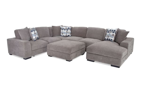 Playground Gray 145'' 4-piece right arm facing sectional with polyester fabric upholstery, memory foam cushions, pop-up sleeper loveseat, storage chaise, and tufted ottoman.