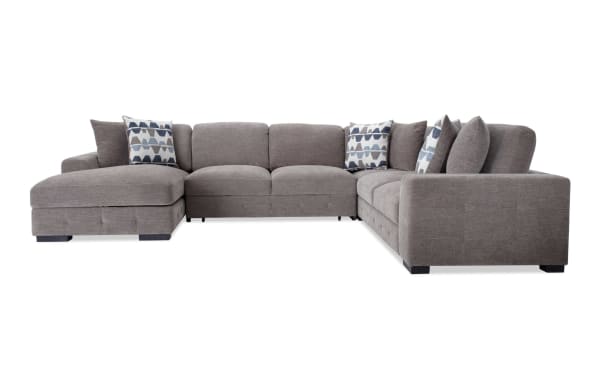 Playground Gray 145" 4-piece left arm facing chaise sectional with armless pop-up sleeper, gray polyester fabric, hand-tufted detailing, oversized accent pillows, and hidden chaise storage in contemporary style.