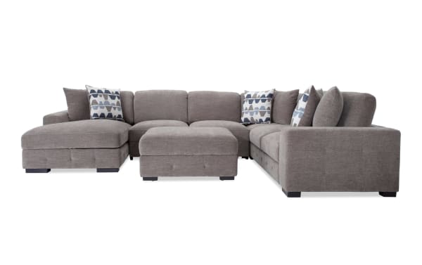 Playground Gray 145'' 4-piece left arm chaise sectional with armless pop-up sleeper and storage ottoman. Contemporary gray polyester fabric with tufted detailing and oversized accent pillows.