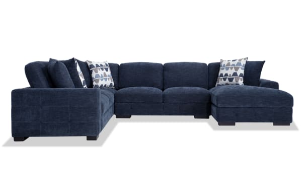 Playground Navy 145'' 4 Piece Right Arm Facing Chaise Sectional in navy blue polyester fabric with deep memory foam cushions, hand-tufted texture, and six oversized accent pillows for contemporary living spaces.