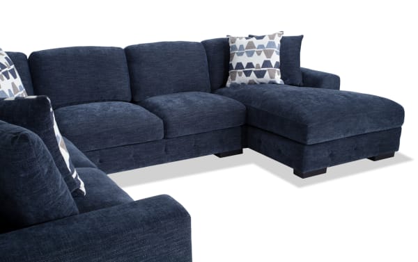 Contemporary Playground Navy 145'' 4-piece right arm facing chaise sectional in plush navy polyester fabric with deep memory foam cushions and tufted detailing.