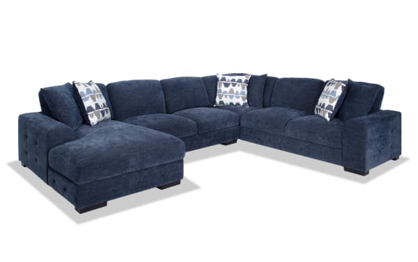 Contemporary Playground Navy 145'' 4 Piece Left Arm Facing Chaise Sectional in plush polyester fabric with deep memory foam cushions and tufted detailing.