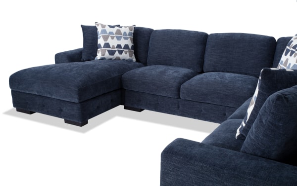 Contemporary Playground Navy 145'' 4-piece left arm facing chaise sectional with plush polyester fabric, deep memory foam cushions, and hand-tufted detailing.