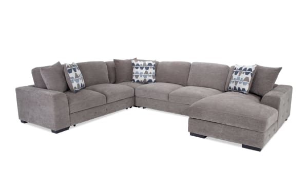 Contemporary Playground Gray 145'' 4-piece right arm facing chaise sectional in gray polyester fabric with deep memory foam cushions and tufted detailing.