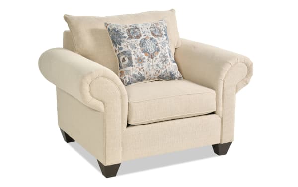 Chloe Beige Chair from Chloe Living collection, transitional style with beige polyester fabric upholstery, rolled arms, dark tapered legs, and a patterned accent pillow.