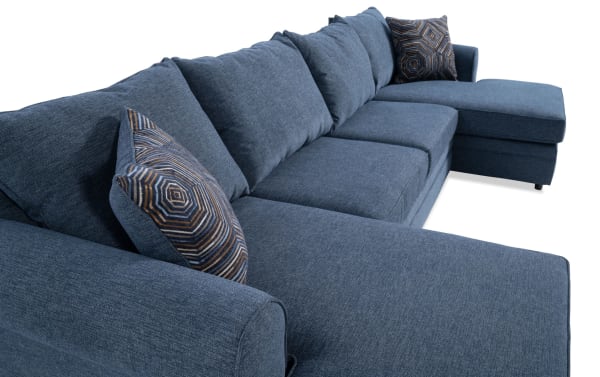 Juno Denim 142'' 3 Piece Dual Chaise Sectional in blue polyester fabric with transitional style, featuring memory foam cushions and patterned accent pillows.