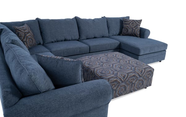 Juno Denim 142" 4-piece right arm facing chaise sectional with ottoman in blue polyester fabric. Transitional style with Bob-O-Pedic memory foam cushions and patterned accent pillows.