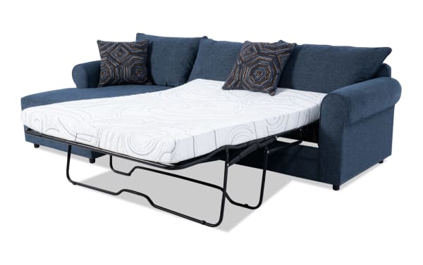 Juno Denim 114'' left arm facing sleeper chaise sectional in blue polyester fabric with transitional style, featuring a full-size pull-out cooling gel memory foam mattress and patterned accent pillows.