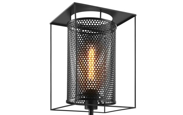 Rustic Luxe Black Table Lamp with geometric metal frame and perforated cylindrical shade, featuring a warm glow and rotary switch for adjustable lighting.