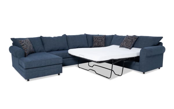 Juno Denim 142" 4-piece left arm facing sleeper chaise sectional in blue polyester fabric with transitional style, featuring a full-size pull-out gel memory foam mattress and patterned accent pillows.