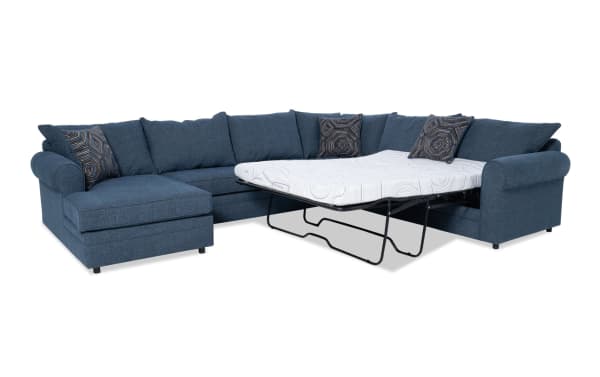 Juno Denim 4-piece left arm facing sleeper chaise sectional in blue polyester fabric with transitional style. Features a full-size pull-out sleeper with cooling Bob-O-Pedic gel memory foam mattress and patterned accent pillows.