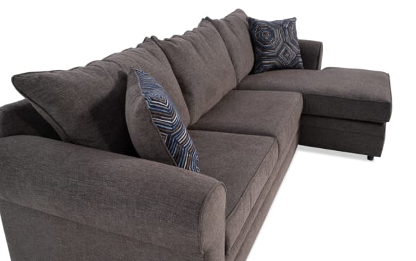 Juno Chocolate 114'' 2 Piece Right Arm Facing Chaise Sectional in brown polyester fabric with transitional style, memory foam cushions, and patterned accent pillows.