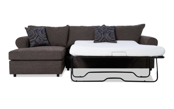 Juno Chocolate 114'' 2 Piece Left Arm Facing Sleeper Chaise Sectional in brown polyester fabric with transitional style, featuring a pull-out gel memory foam mattress and patterned accent pillows.