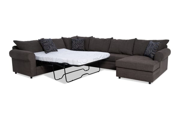 Juno Chocolate 142'' 4 Piece Right Arm Facing Transitional Sleeper Chaise Sectional in brown polyester fabric with cooling Bob-O-Pedic memory foam mattress and patterned accent pillows.