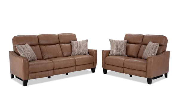 Empire Cognac leather 82" power reclining sofa and 59" loveseat set in brown transitional style with vinyl accents, power headrests, and accent pillows.