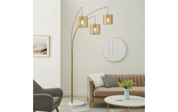 Contemporary Celine Gold Arc Floor Lamp with three gold metal arches and mesh glass shades, white faux marble base, perfect for modern living rooms.