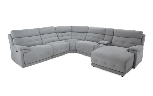 Rumor Gray 132'' power reclining 6-piece right arm facing chaise sectional in gray polyester fabric with power headrests, cup holders, USB ports, and memory foam cushions. Contemporary style with plush tufted upholstery, storage console, and chaise lounge.