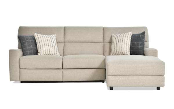 Modern Farmhouse beige 132" 2-piece right arm facing power reclining sleeper chaise sectional in polyester fabric with power headrest, accent pillows, and gel mattress.