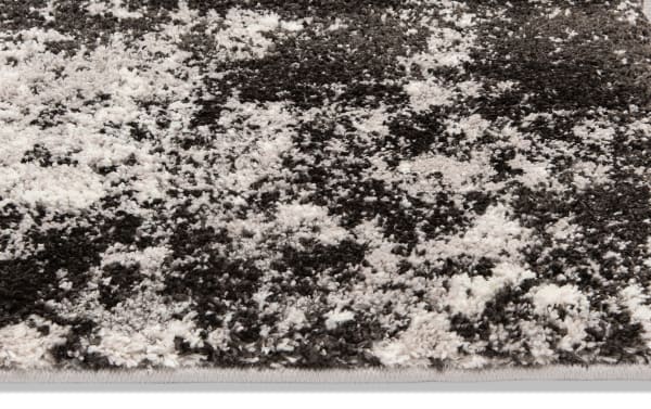 Transitional Galaxy 8' x 10' Black Abstract Rug with heat set polypropylene fabric, featuring a neutral black and white abstract pattern for modern living spaces.