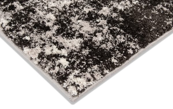 Transitional Galaxy 8' x 10' Black Abstract Rug with heat set polypropylene fabric in black and white, featuring a textured abstract pattern.