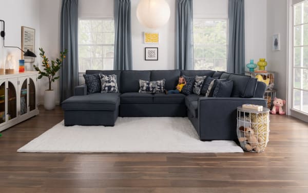 Gray Playmax Denim 124'' 4-piece left arm facing pop-up sleeper chaise sectional in transitional style with polyester fabric upholstery, USB/USB-C ports, and accent pillows.