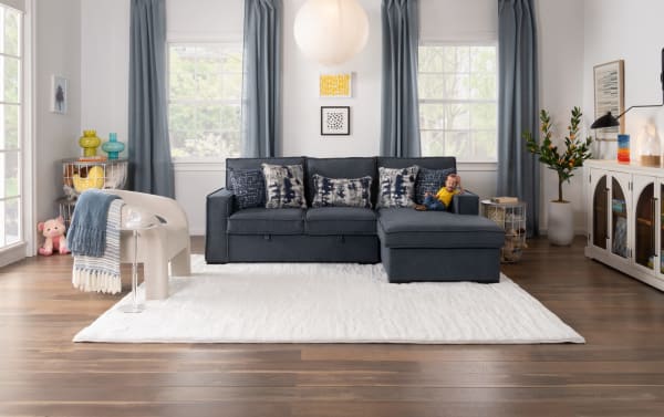 Gray Playmax Denim 94'' 2-piece right arm facing pop-up sleeper chaise sectional with polyester fabric, USB/USB-C ports, accent pillows, and matching gray accent chair.