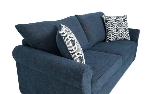 Transitional Slumber Navy 80'' sleeper sofa in blue polyester fabric with plush cushions, accent pillows, and a cooling queen pull-out mattress.