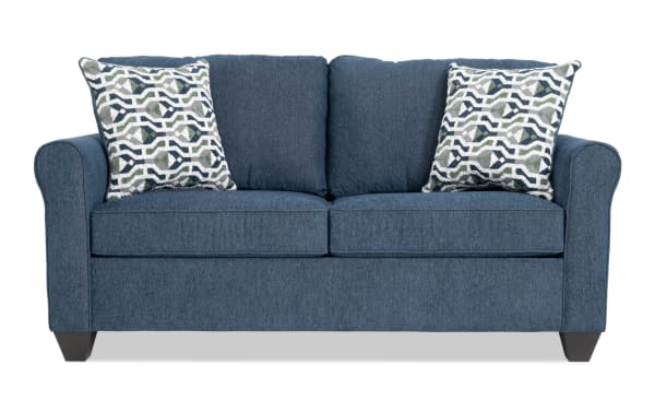 Transitional Slumber Navy 72" sleeper sofa in blue polyester fabric with plush cushions, patterned accent pillows, and full gel memory foam mattress.